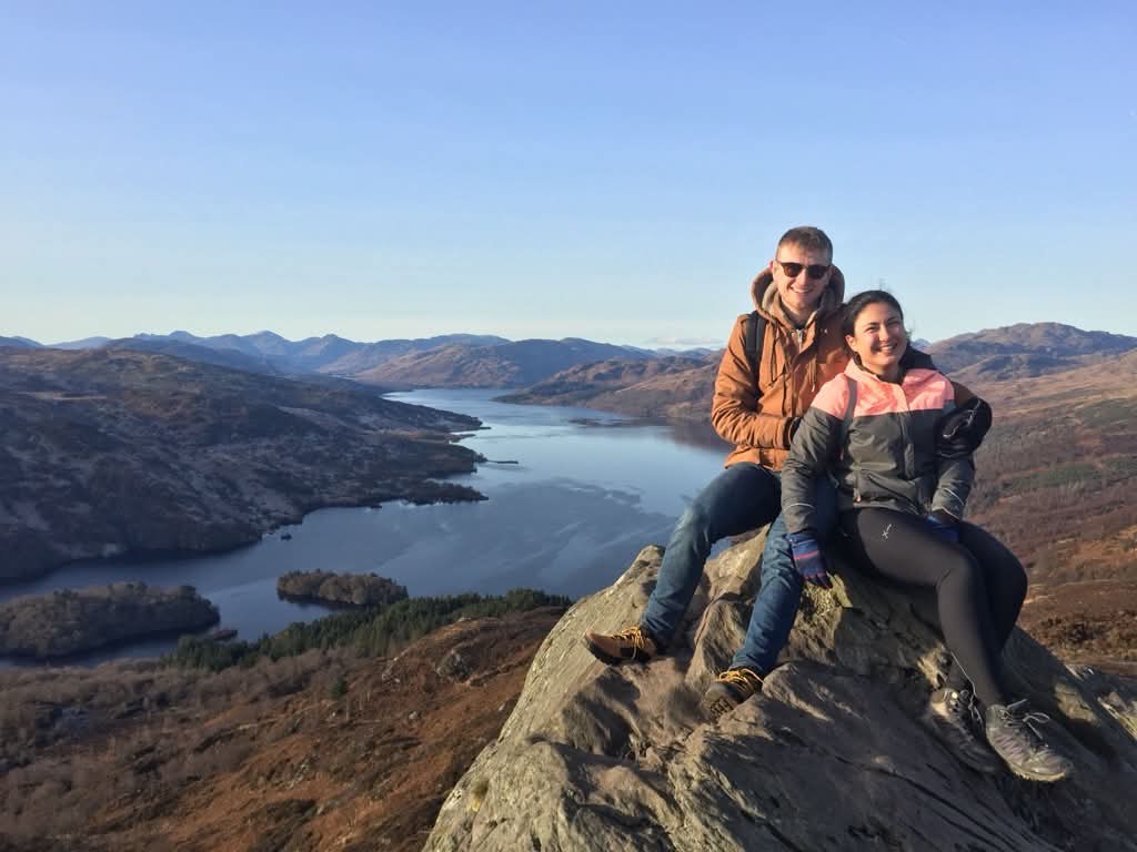 Luisa and Tom hiking above a loch