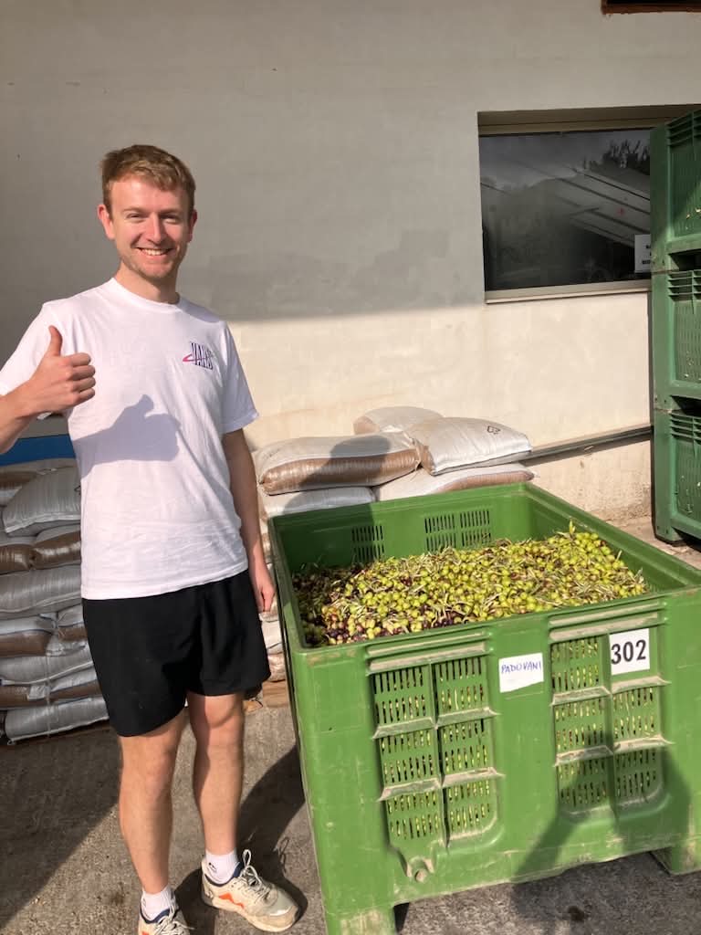 Tom beside a crate of Sicilian olives
